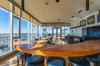 a dining room with a large wooden table and a view of the city